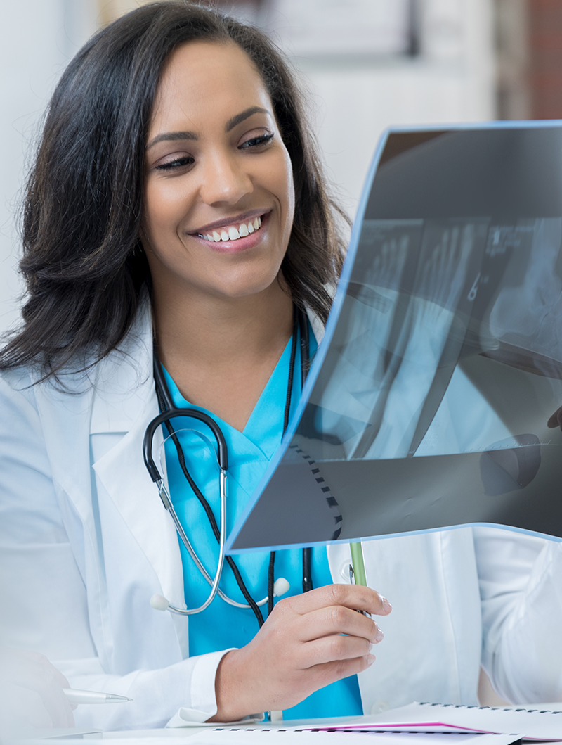 Female Doctor Looking at X-Ray